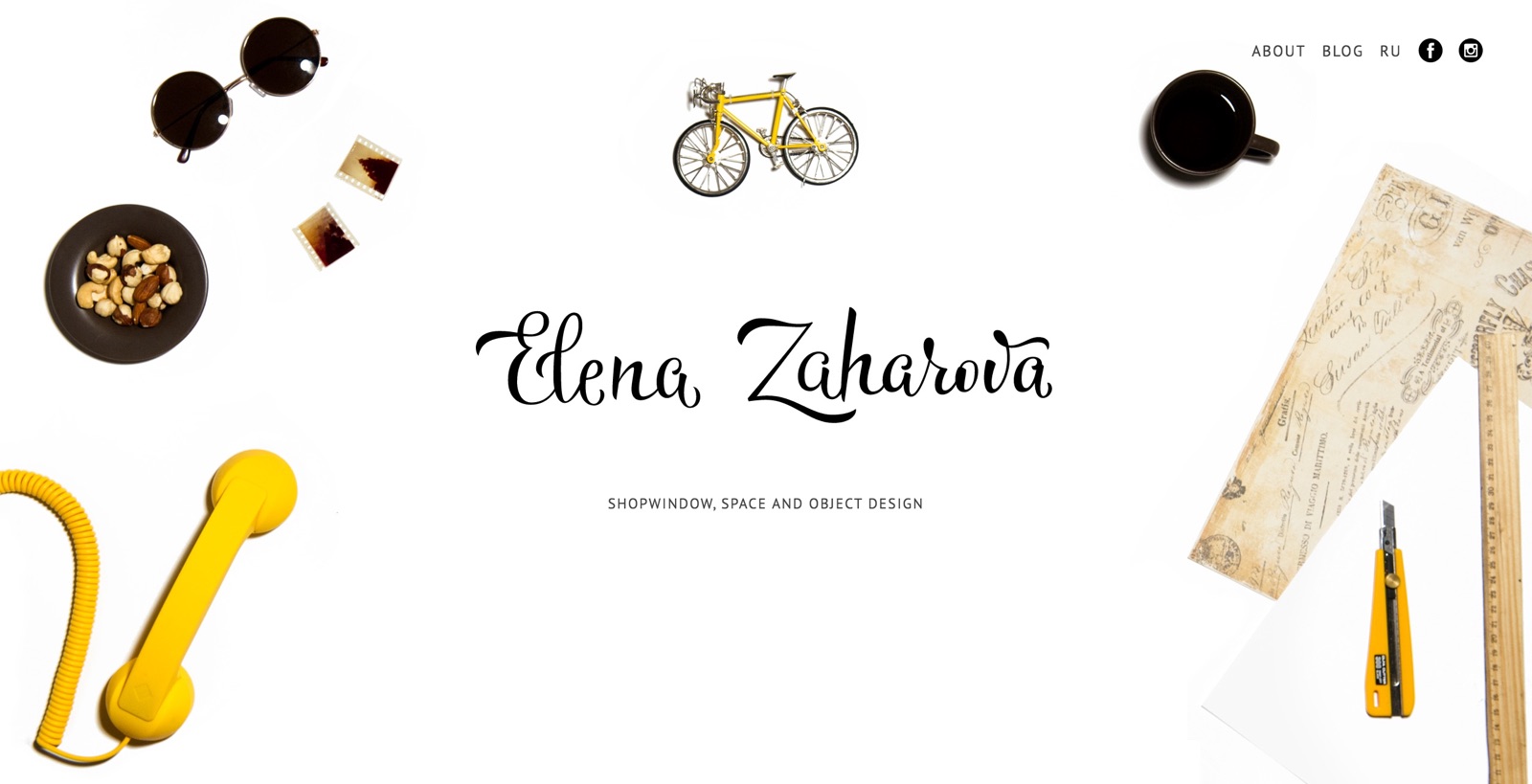 Elena Zaharova’s table with sunglasses, toy bicycle, tea cup, photo negatives and sketches